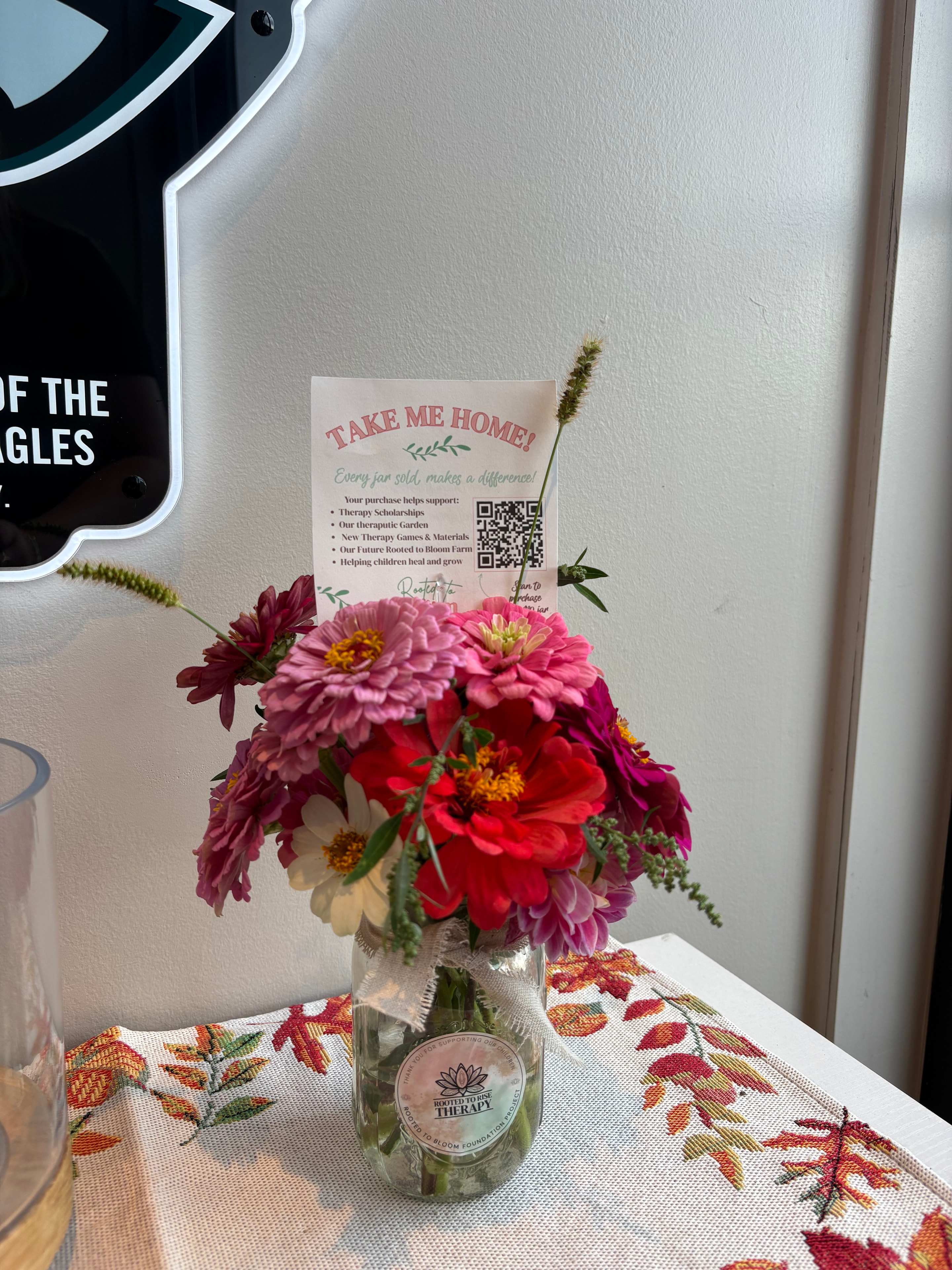 Pink zinnia bouquet in branded jar with Take Me Home card